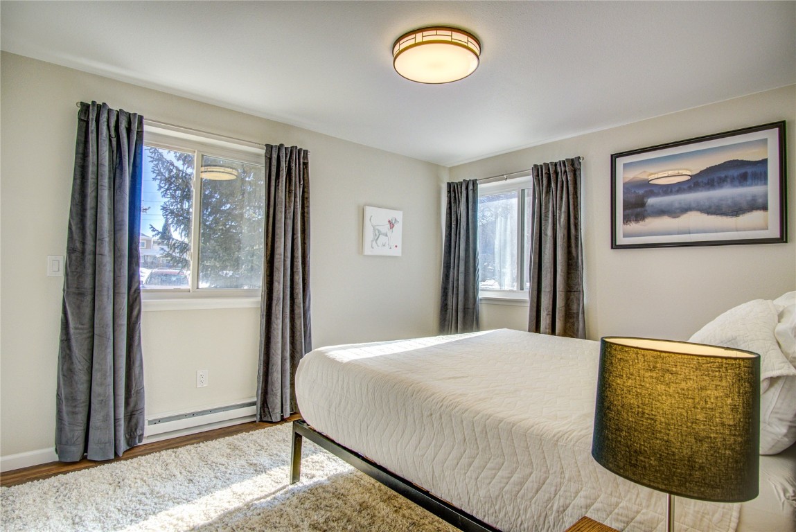 78 Summit Drive, Unit C11 Dillon, CO 80435 - Photo 13 of 21 a bedroom with a bed and a painting on the wall