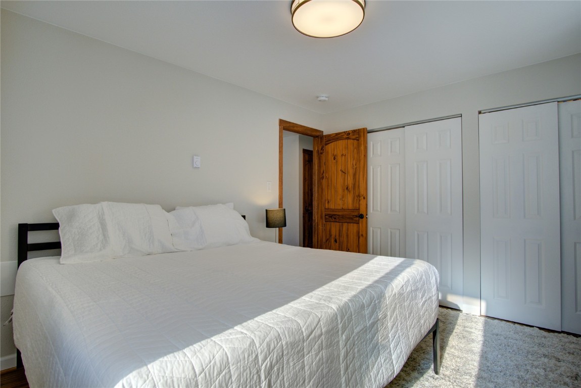 78 Summit Drive, Unit C11 Dillon, CO 80435 - Photo 15 of 21 a bedroom with a bed and a lamp