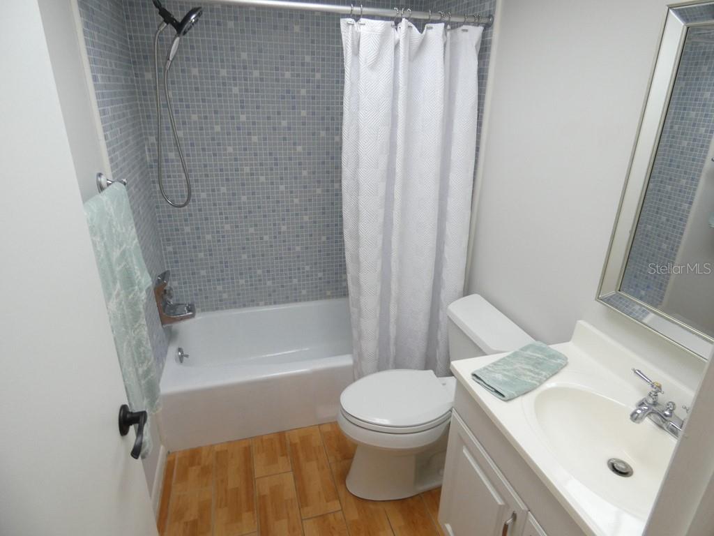 1701 Pinehurst Road, Unit 9G Dunedin, FL 34698 - Photo 8 of 22 a bathroom with a sink toilet and shower