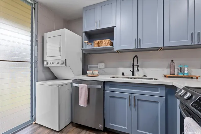 a kitchen with stainless steel appliances a sink a stove and a microwave