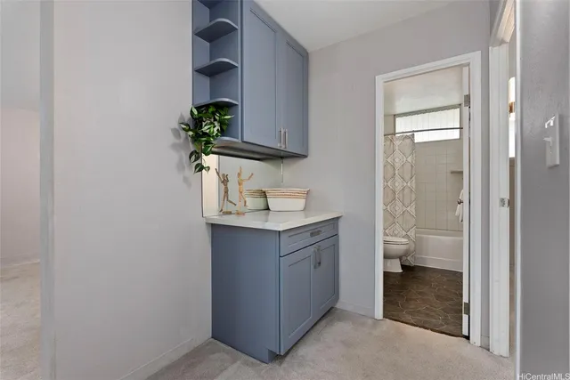 a bathroom with a granite countertop sink a toilet and a mirror