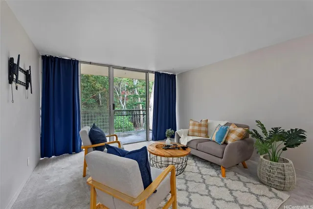 a living room with furniture and floor to ceiling window