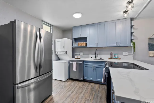 a kitchen with stainless steel appliances granite countertop a refrigerator sink and stove