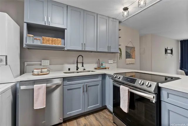 a kitchen with stainless steel appliances granite countertop a sink a stove a microwave and cabinets