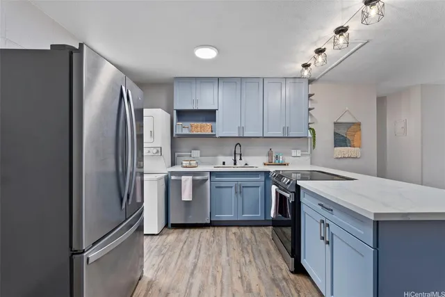 a kitchen with a refrigerator a sink and dishwasher with wooden floor