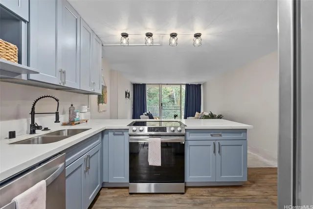 a kitchen with a stove sink and cabinets