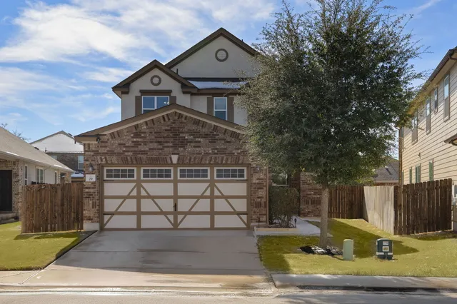 a view of a house with wooden fence