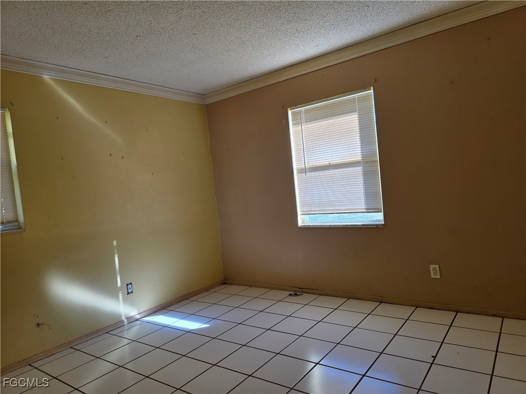 308 Stanford Street Lehigh Acres, FL 33936 - Photo 7 of 14 a view of an empty room and window