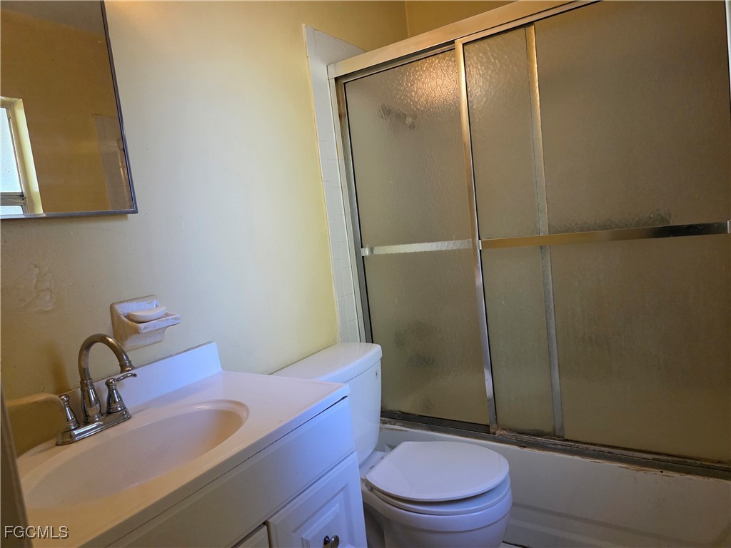308 Stanford Street Lehigh Acres, FL 33936 - Photo 9 of 14 a bathroom with a sink a toilet and shower