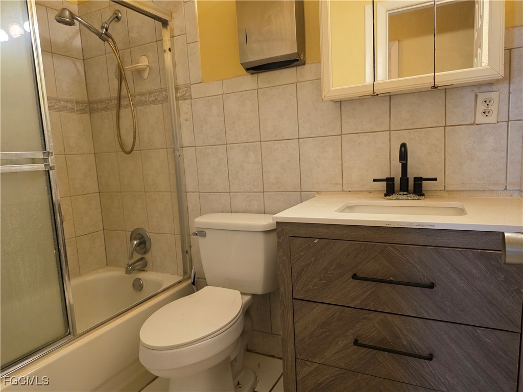308 Stanford Street Lehigh Acres, FL 33936 - Photo 10 of 14 a bathroom with a sink a toilet and shower