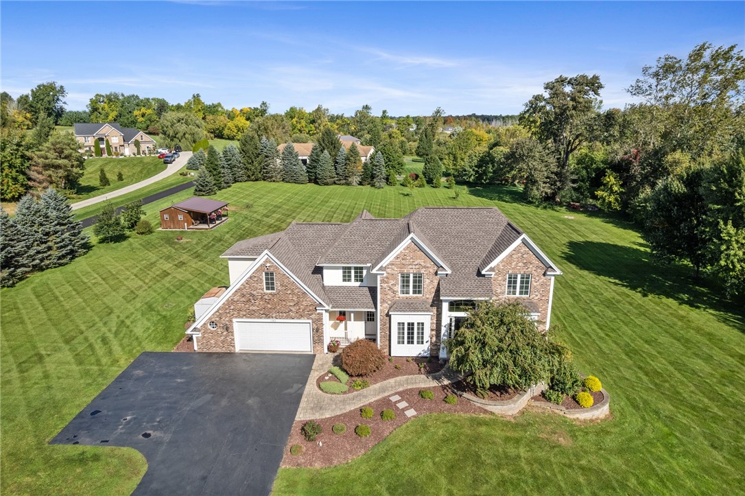 1782 Sweets Corners Road Penfield, NY 14450 - Photo 2 of 49 An elegant brick and stone facade anchors this classic home nestled on expansive green lawns.