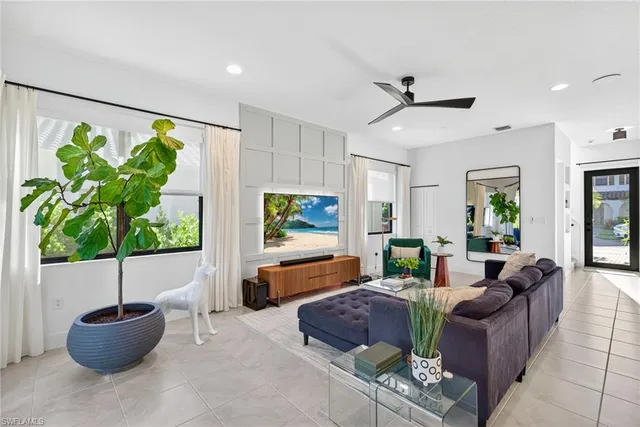 a living room with furniture and a potted plant