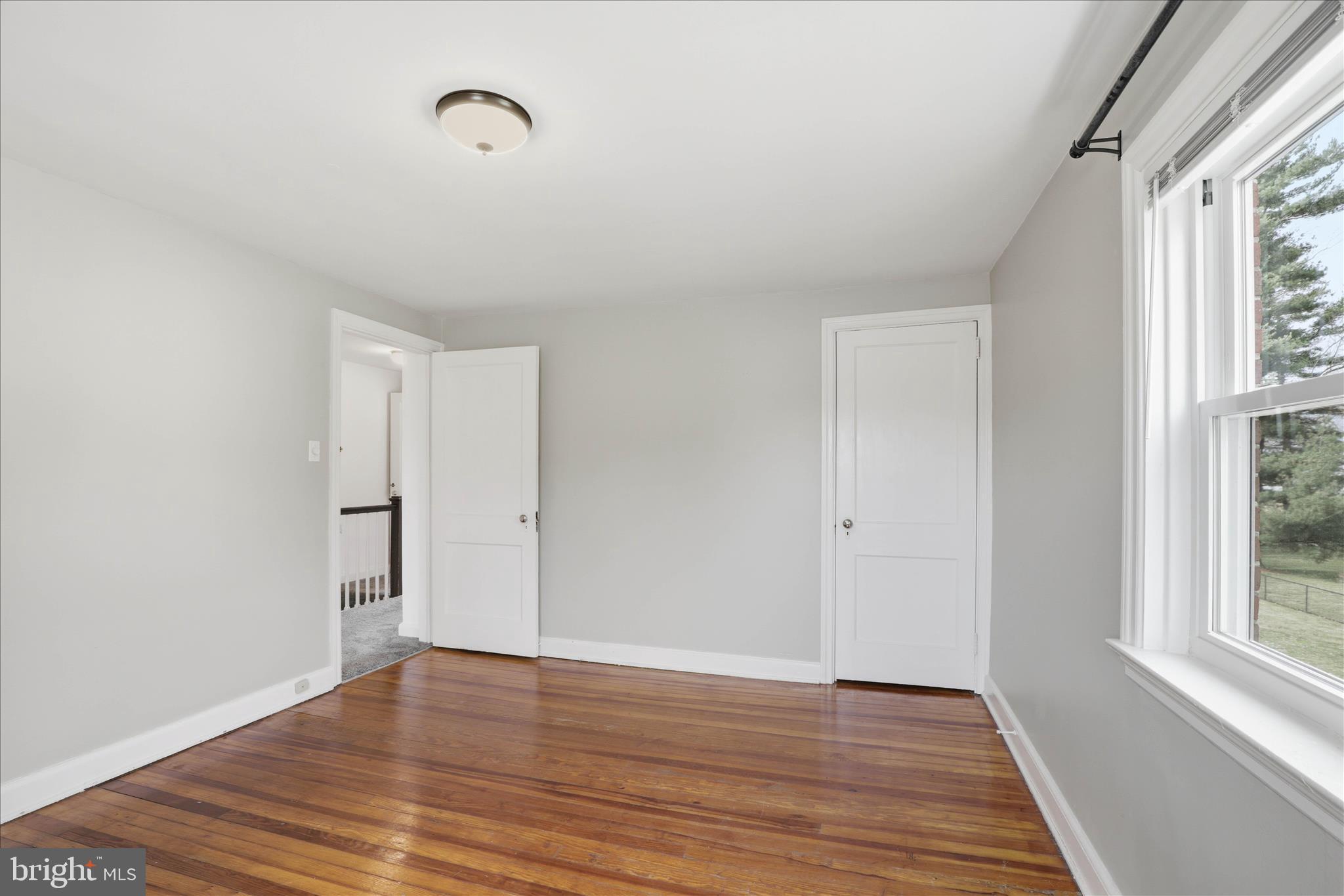 1630 Lampeter Road Lancaster, PA 17602 - Photo 30 of 49 a view of an empty room with wooden floor and a window