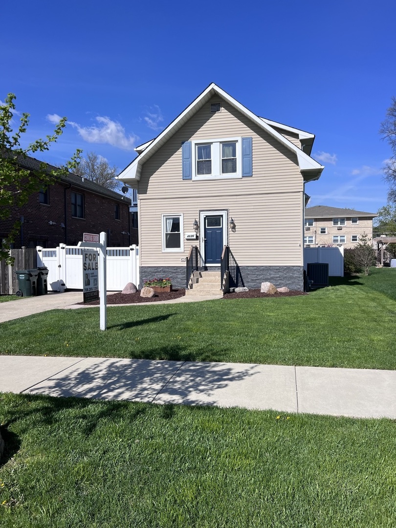 4636 Custer Avenue Brookfield, IL 60513 - Photo 1 of 23 a front view of a house with a yard and garage
