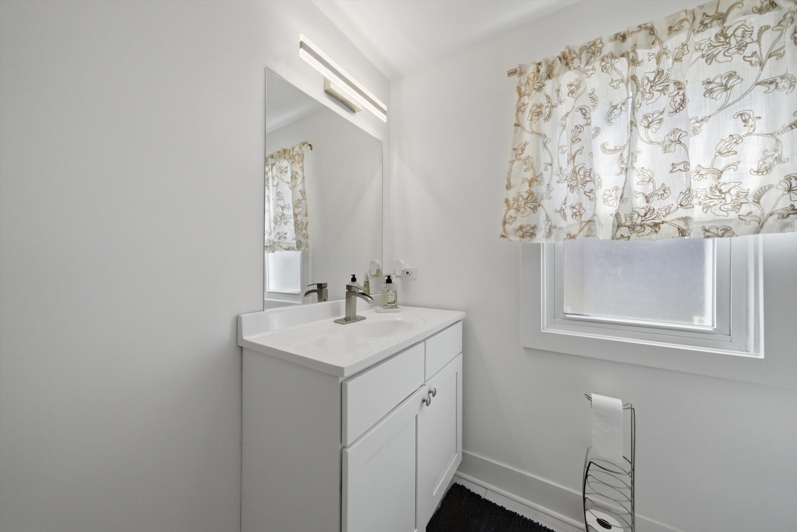 4636 Custer Avenue Brookfield, IL 60513 - Photo 9 of 23 a bathroom with a sink and a mirror