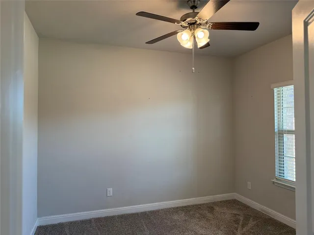 a large kitchen with cabinets and wooden floor