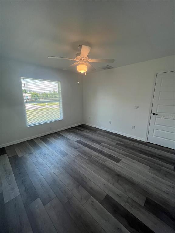 68 Evergreen Street Punta Gorda, FL 33982 - Photo 7 of 8 an empty room with wooden floor and windows