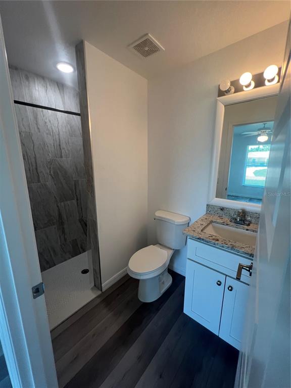 68 Evergreen Street Punta Gorda, FL 33982 - Photo 8 of 8 a bathroom with a granite countertop sink toilet and shower