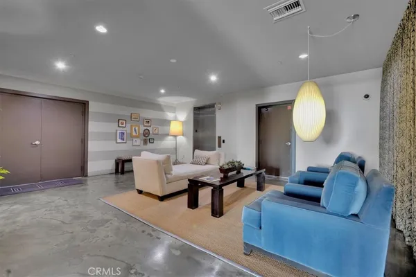 a living room with furniture and a chandelier