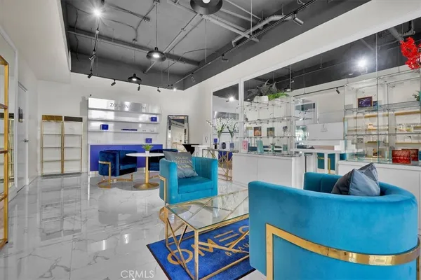 a kitchen with stainless steel appliances kitchen island granite countertop a table chairs in it and wooden floor