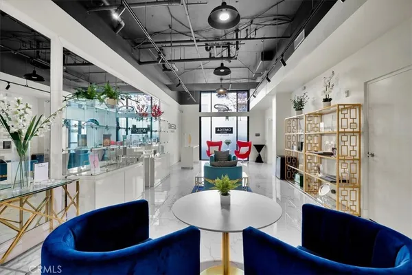 a living room with furniture and a floor to ceiling window