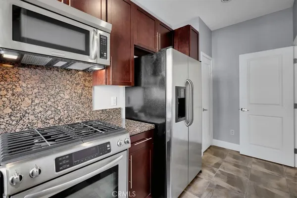 a view of a patio with a table and chairs