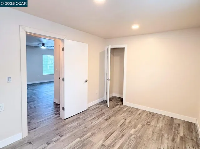 a view of hallway with wooden floor