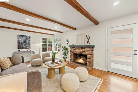 a kitchen with stainless steel appliances a dining table chairs and a refrigerator