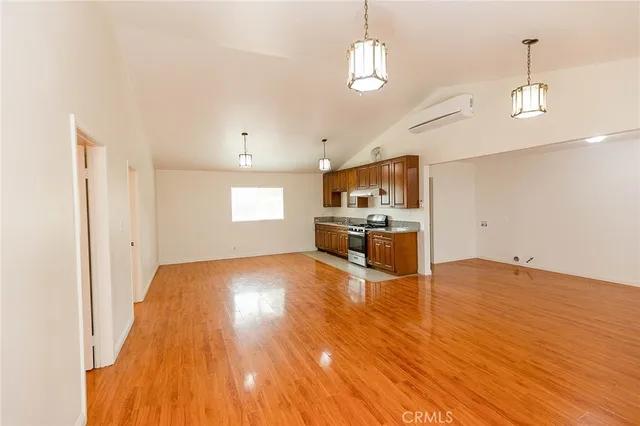 a view of kitchen and hall with wooden floor