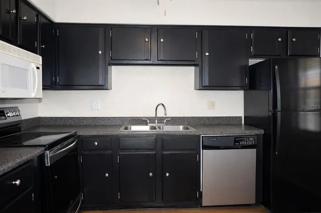 a kitchen with a sink and cabinets