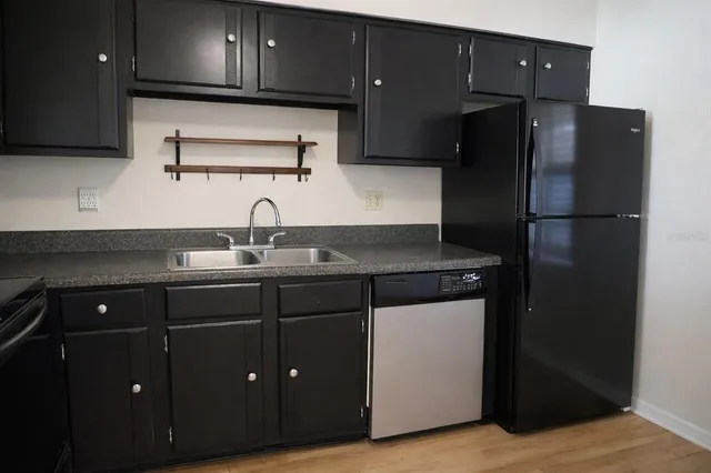 a kitchen with a sink and refrigerator