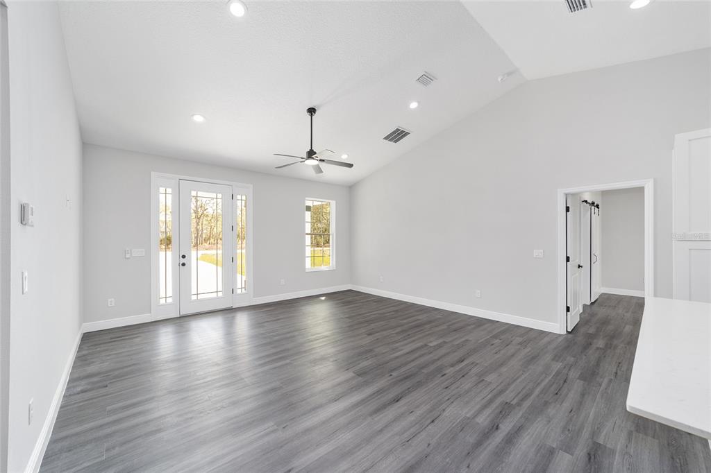 1370 Northeast 151 Avenue Williston, FL 32696 - Photo 14 of 51 a view of an empty room with wooden floor and a window