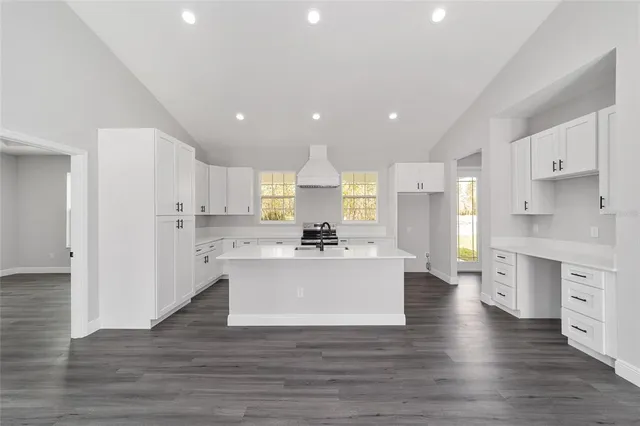 a view of kitchen with stainless steel appliances refrigerator stove microwave and cabinets