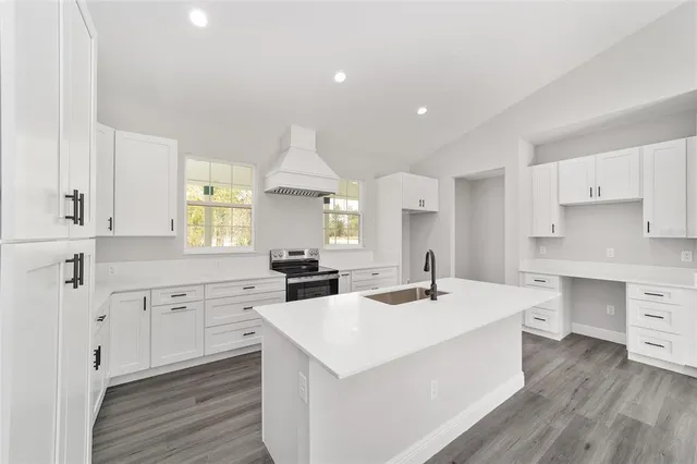 a kitchen with a sink stove and cabinets