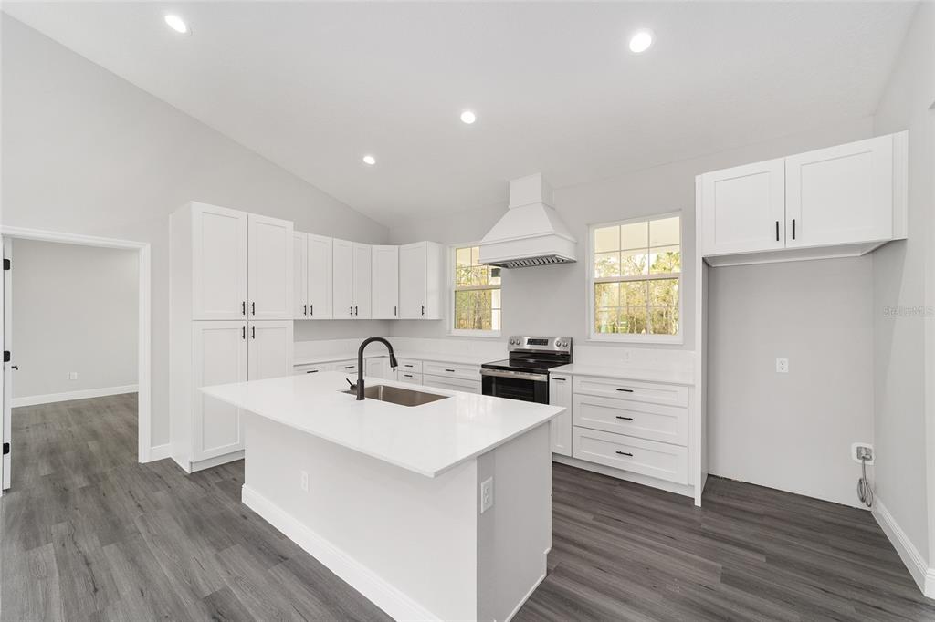 1370 Northeast 151 Avenue Williston, FL 32696 - Photo 17 of 51 a kitchen with granite countertop a sink stove and cabinets