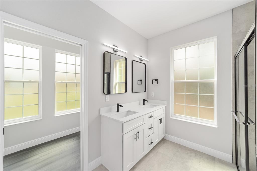 1370 Northeast 151 Avenue Williston, FL 32696 - Photo 24 of 51 a bathroom with double vanity and a window