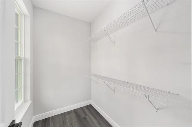 a view of a room with wooden floor