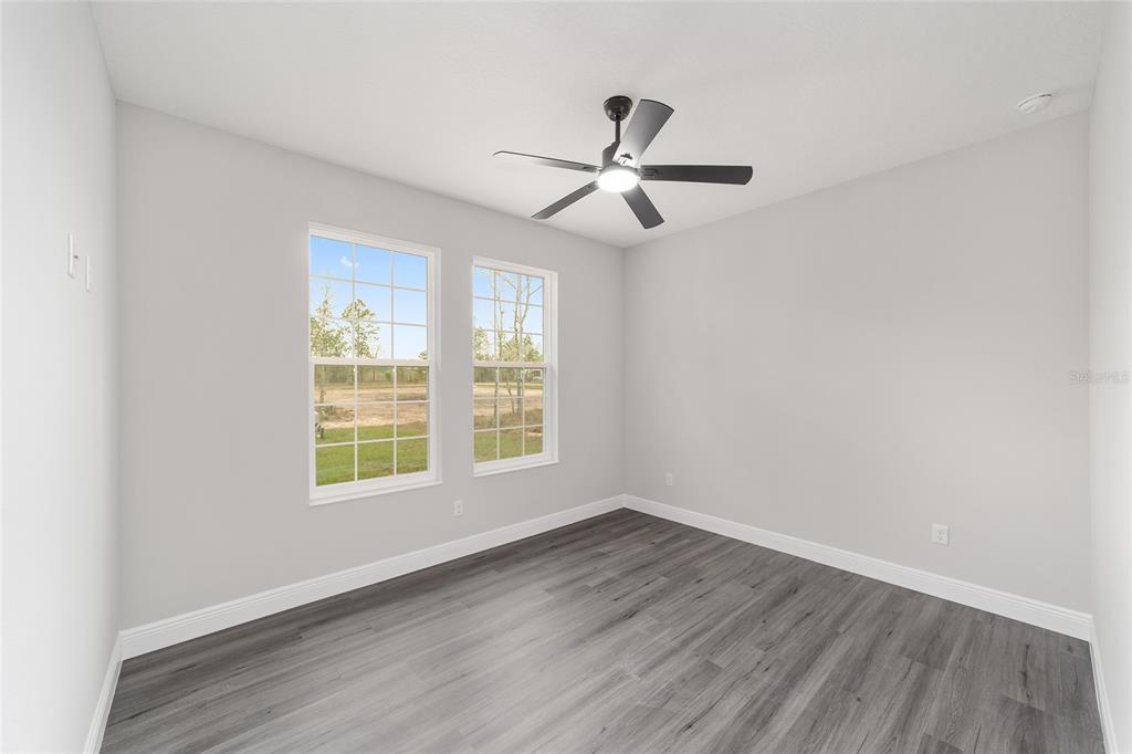 1370 Northeast 151 Avenue Williston, FL 32696 - Photo 31 of 51 a view of empty room with wooden floor and fan