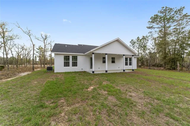 a view of a house with a backyard