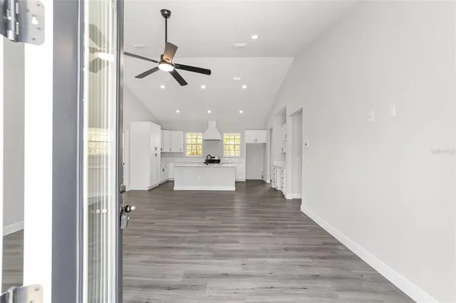 a view of kitchen and hall with wooden floor