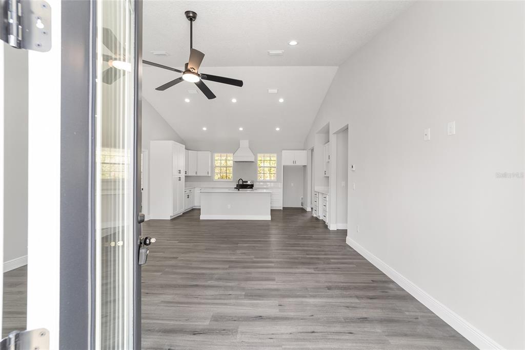 1370 Northeast 151 Avenue Williston, FL 32696 - Photo 10 of 51 a view of kitchen and hall with wooden floor