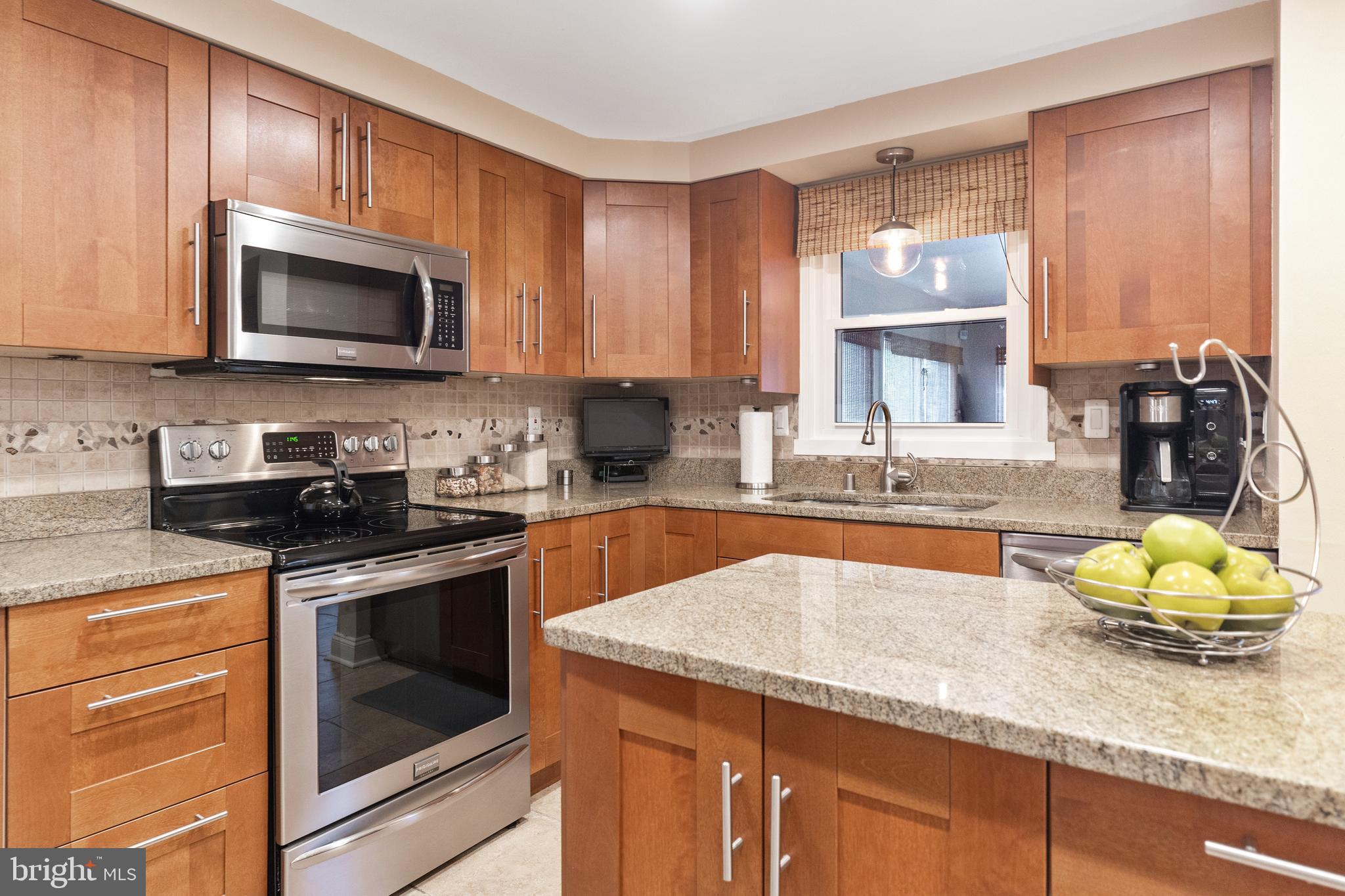 7616 Blue Grass Road Rosedale, MD 21237 - Photo 15 of 50 a kitchen with granite countertop a sink stainless steel appliances and cabinets