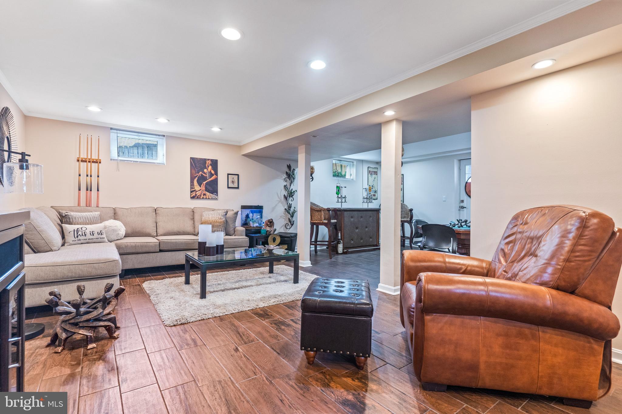 7616 Blue Grass Road Rosedale, MD 21237 - Photo 35 of 50 a living room with furniture and a wooden floor