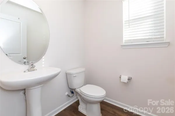 a bathroom with a sink a mirror and a toilet