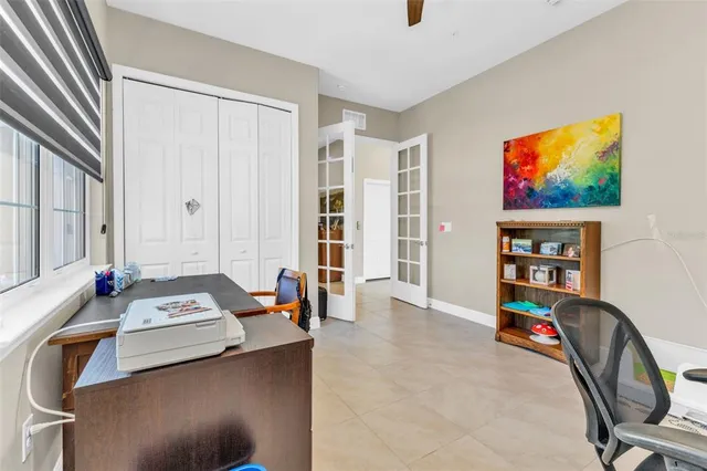 a bedroom with a bed and a dresser next to a window