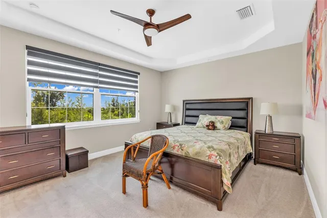 a view of a bedroom with wooden floor and flat screen tv