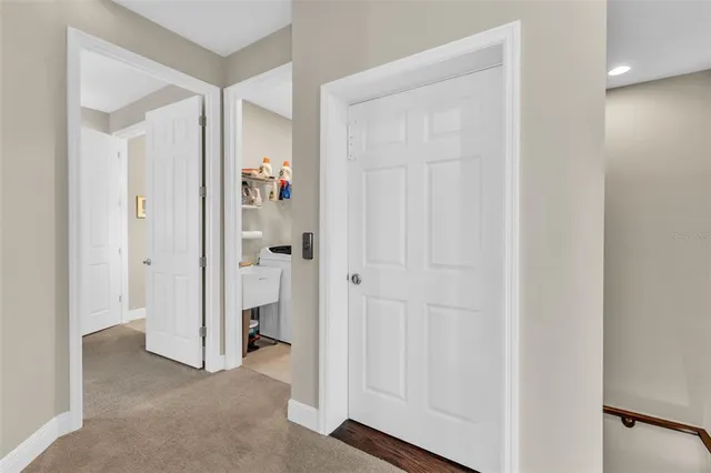 a view of a hallway with a door and stairs