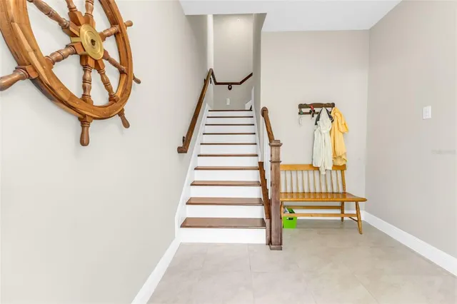 a kitchen with kitchen island a white counter top space cabinets and stainless steel appliances