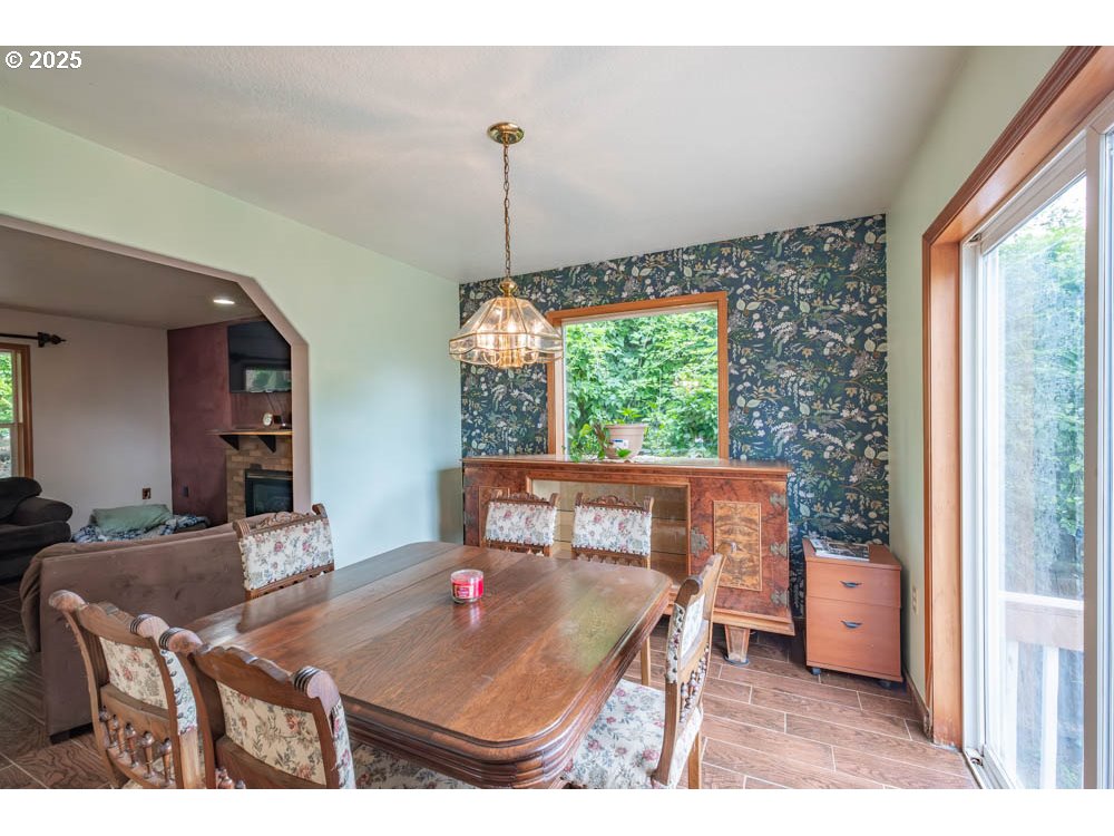 609 Van Buren Street Oregon City, OR 97045 - Photo 13 of 34 a view of a dining room with furniture window and wooden floor