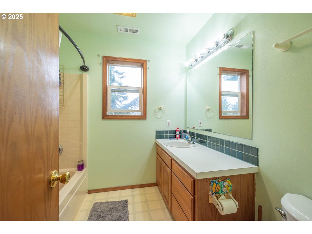 609 Van Buren Street Oregon City, OR 97045 - Photo 24 of 34 a bathroom with a sink and a mirror